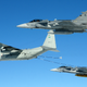 Two Saab JAS-39 fighters of the Czech Air Force receive fuel from a Swedish Air Force Hercules in 2016 (Milan Nykodym)